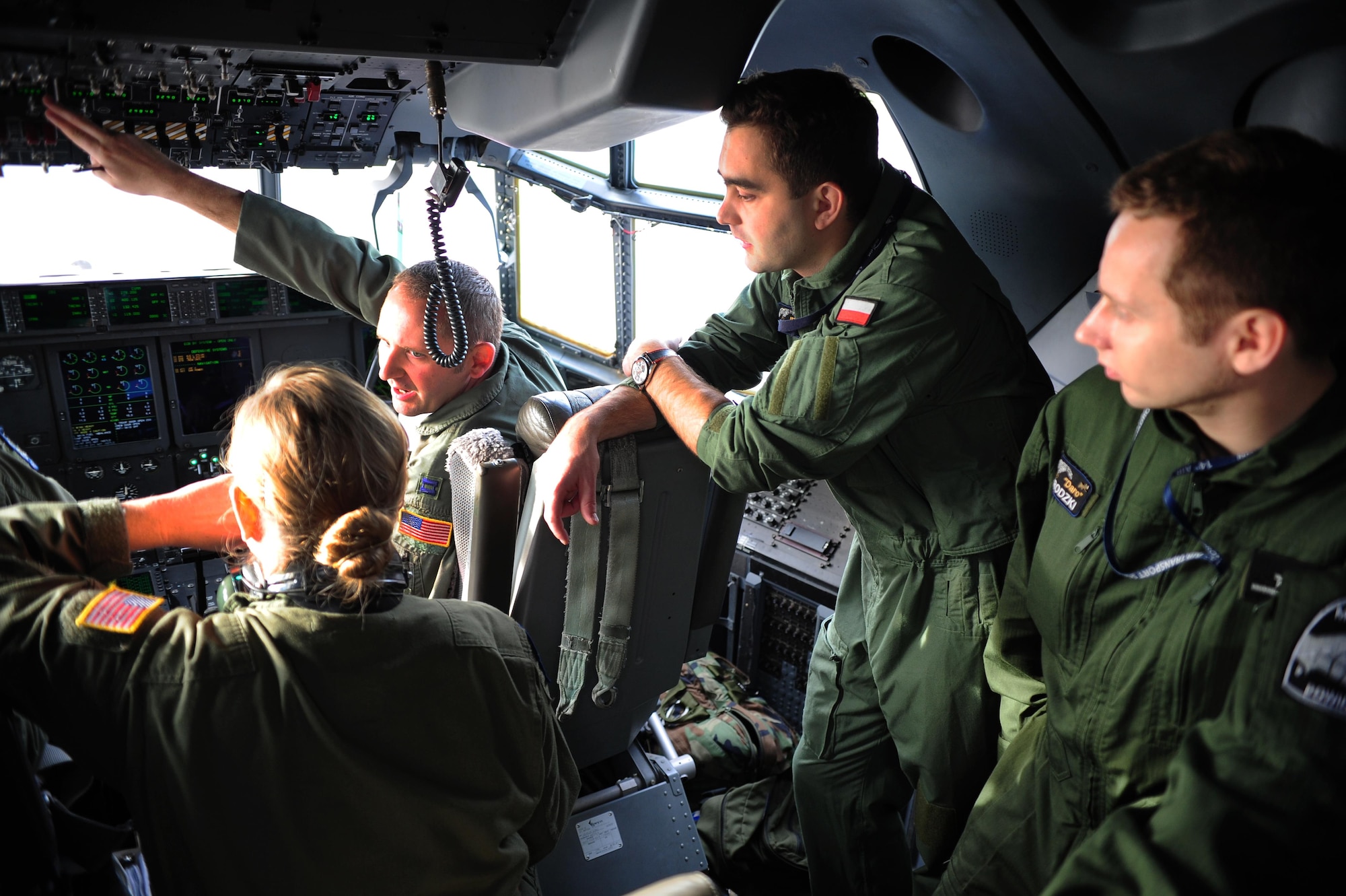 Pilots from the Polish air force and Airmen from the 37th Airlift Squadron go through a pre-flight brief during a theater security cooperation event, Oct. 21, 2013, Powidz Air Transport Base, Poland. Airmen from Ramstein Air Base, Germany got a unique opportunity to work hand-in-hand with their Polish counterparts. 