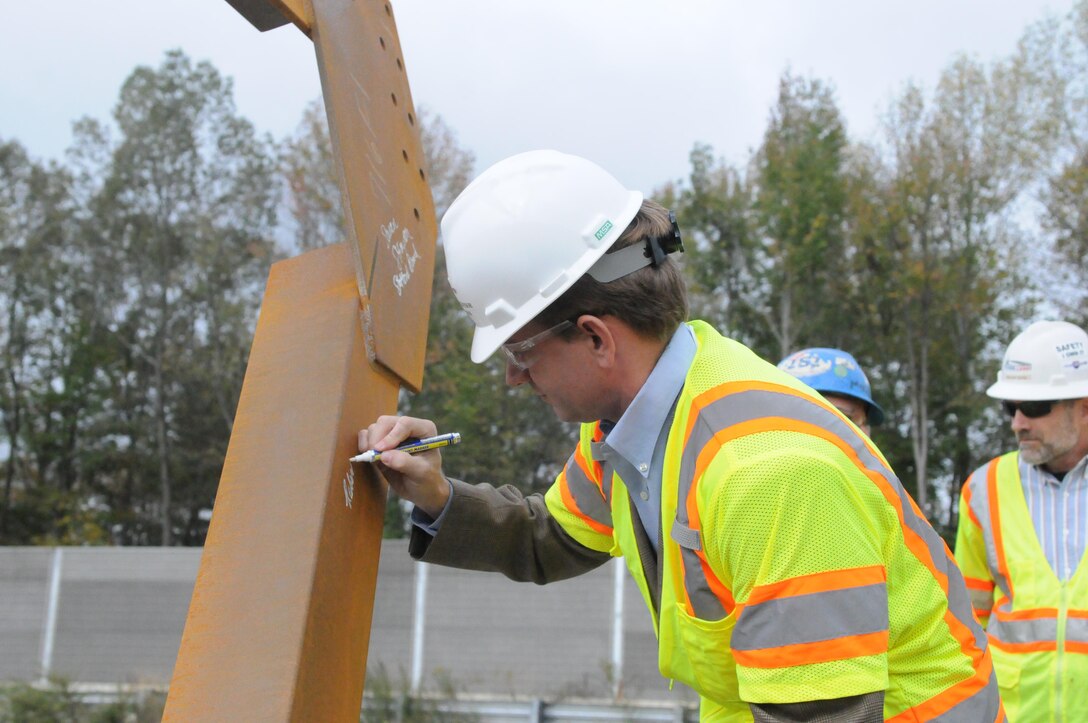 Bob Thomas of the Stafford County Board of Supervisors signs a crossframe that will be part of the flyover from the Interstate 95 high-occupancy toll lanes to Garrisonville Road. Thomas and Board of Supervisors Chairwoman Susan Stimpson joined builders and Virginia Department of Transportation representatives to celebrate the halfway mark in HOT lanes construction Oct. 16. 