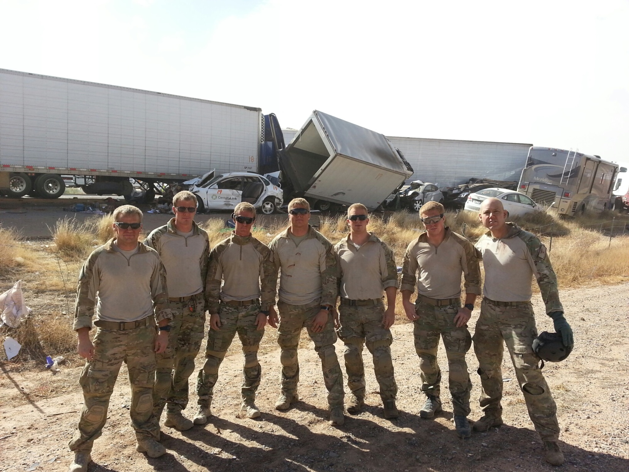 Airmen from the 48th Rescue Squadron at Davis-Monthan Air Force Base, Ariz., stand by a 19 vehicle accident on Interstate 10 near Picacho Peak, Ariz., Oct. 29, 2013. The Airmen extracted five people from vehicles, coordinated four medical helicopter flights, and organized ground transportation for about six injured individuals.