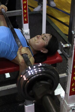 Sayaka Takabayashi, 131-pound competitor and first place winner, prepares to press 47.5 kilograms (104.5 pounds) during the 2012 Summer Slam Bench Press Competition at the IronWorks Gym sports courts here June 2. Approximately 28 participants competed, divided into male and female categories comprised of ten weight classes.