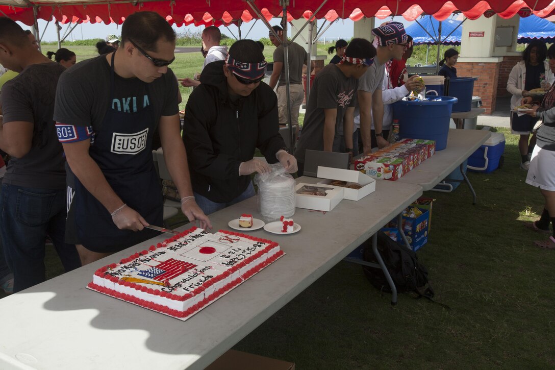 Volunteers with the USO serve cake during a luncheon Oct. 26 at Camp Kinser following a softball game between local players and a 3rd Marine Logistics Group team. The event was a way to continue the relationship between community athletes and Okinawa-based service members and their families. The luncheon was sponsored in part by Marine Corps Community Services Okinawa and the USO. 3rd MLG is a part of III Marine Expeditionary Force.