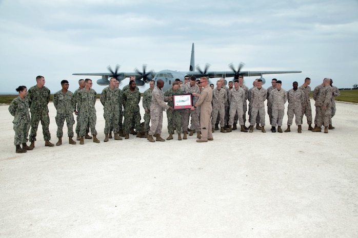 Lt. Col. Jason W. Julian, center right, presents a plaque of appreciation to Lt. Col. Nick Brown Oct. 28 at the Ie Shima Training Facility. Julian is the commanding officer of VMGR-152, MAG-36, 1st MAW, III MEF. Brown is the commanding officer of MWSS-172, 1st MAW.
(U.S. Marine Corps photo by Lance Cpl. Natalie M. Rostran/Released)
