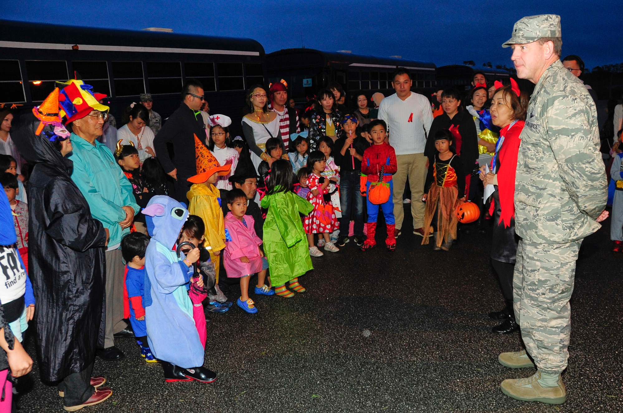 U.S. Air Force Brig. Gen. James Hecker, 18th Wing commander, greets the local national trick-or-treaters through translator Takako Fukuhara, 18th Wing Public Affairs community relations chief, during Halloween on Kadena Air Base, Japan, Oct. 31, 2013. Kadena hosted more than 180 local trick-or-treaters for these Halloween festivities. Kadena transported local community children on base to experience this holiday. (U.S. Air Force photo by Staff Sgt. Darnell T. Cannady)