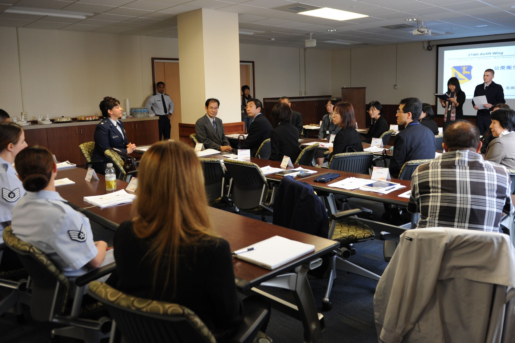 Professionals from the 374th Aeromedical Squadron Public Health Flight meet with members of the Nishitama Public Health Department Oct. 25, 2013, at Yokota Air Base, Japan. The two organizations meet every other year at Yokota. During this year's visit the 374 AMDS demonstrated its capabilities for patient decontamination and also shared meals ready to eat. (U.S. Air Force photo by Senior Airman Desiree Economides/released)