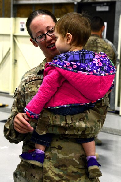 Capt. Lindsay Jaszkowiak, 819th RED HORSE Squadron project officer, greets her daughter at Malmstrom Air Force Base.  Jaszkowiak returned to Malmstrom Oct. 24 after her nearly seven-month deployment.  (U.S. Air Force photo/Staff Sgt. R.J. Biermann)