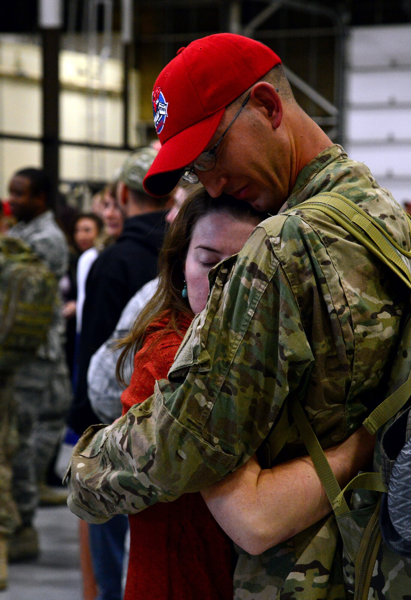 A young woman embraces her husband after his return to Malmstrom Air Force Base on Oct. 24. One hundred and seventy 819th and 219th RED HORSE Squadron Airmen were deployed to Afghanistan and Southwest Asia for the past seven months (U.S. Air Force photo/Staff Sgt. R.J. Biermann)