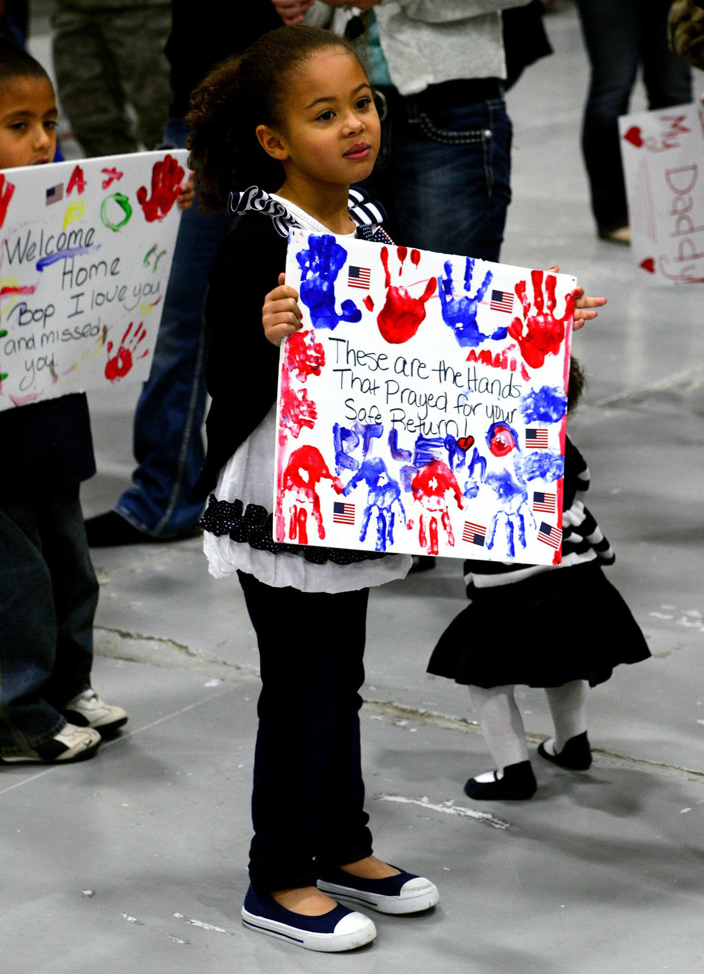 A young girl waits for a loved one to return to Malmstrom Air Force Base from their deployment Oct. 24. One hundred and seventy Airmen from the 819th and 219th RED HORSE Squadrons returned from their seven-month absence. (U.S. Air Force photo/Staff Sgt. R.J. Biermann)
