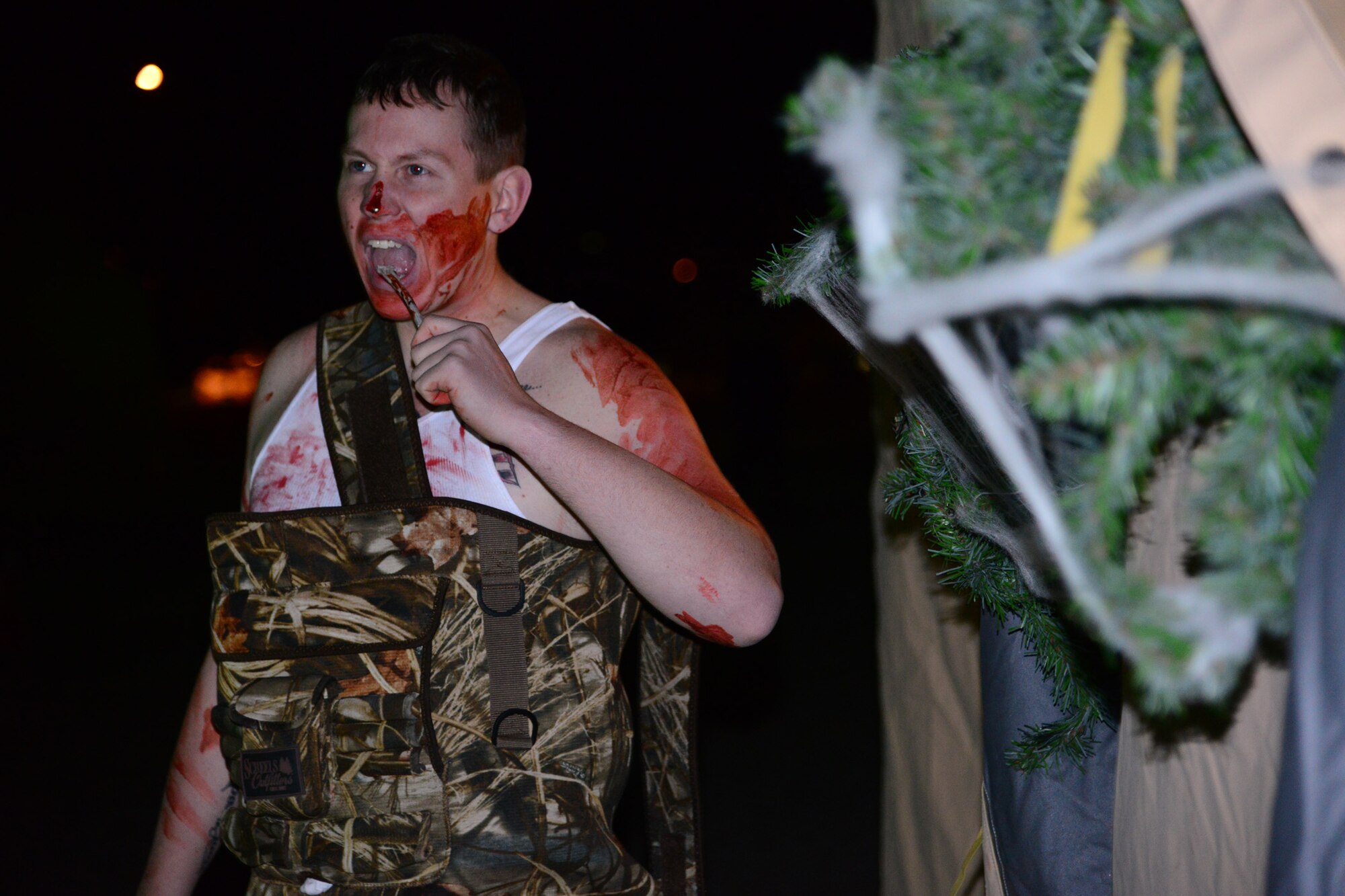 Senior Airman Justin Korus, 341st Security Forces Group member, stands guard at the door of a tent as part of a haunted house at the FamCamp Annex, sponsored by the Outdoor Recreation Center on Oct. 25. More than 60 Team Malmstrom members from five different squadrons volunteered for the event. (U.S. Air Force photo/Airman 1st Class Collin Schmidt