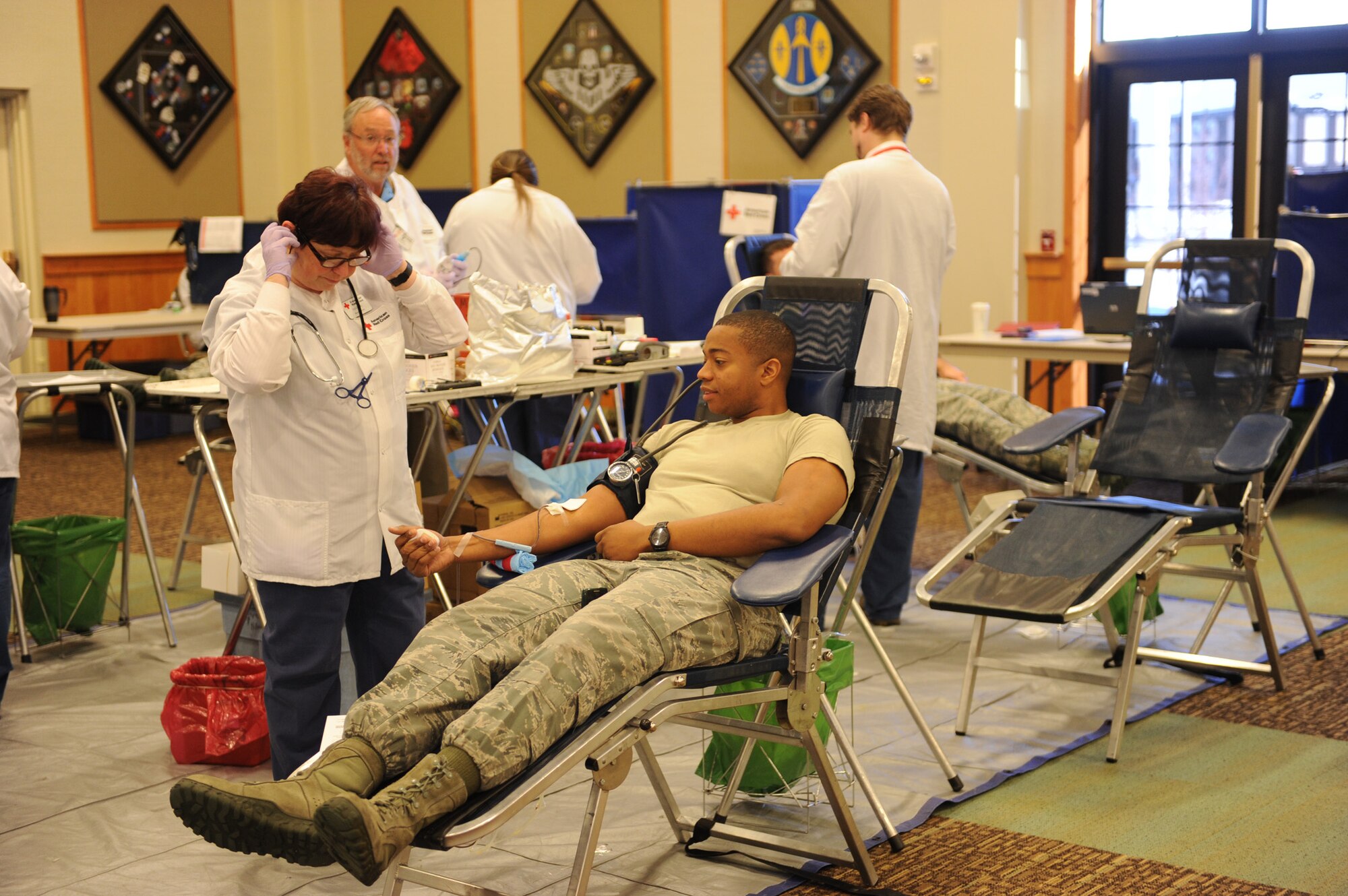 Marina Gesina, Great Falls American Red Cross phlebotomist (left), observes 2nd Lt. Charles Frazier, 341st Missile Maintenance Squadron electro-mechanical team officer in charge and monthly blood drive director, as he donates blood during the 1st Strike Blood Drive Challenge at the Grizzly Bend on Oct. 29. Sponsored by the first sergeants’ council, the competition is amongst the five Malmstrom groups, as well as Wing Staff Agencies and the 819th RED HORSE Squadron, to see which group can donate the most blood during two blood drives. The second blood drive is scheduled for Nov. 26 at the Grizzly Bend from 10 a.m. to 3 p.m. (U.S. Air Force photo/Christy Mason)