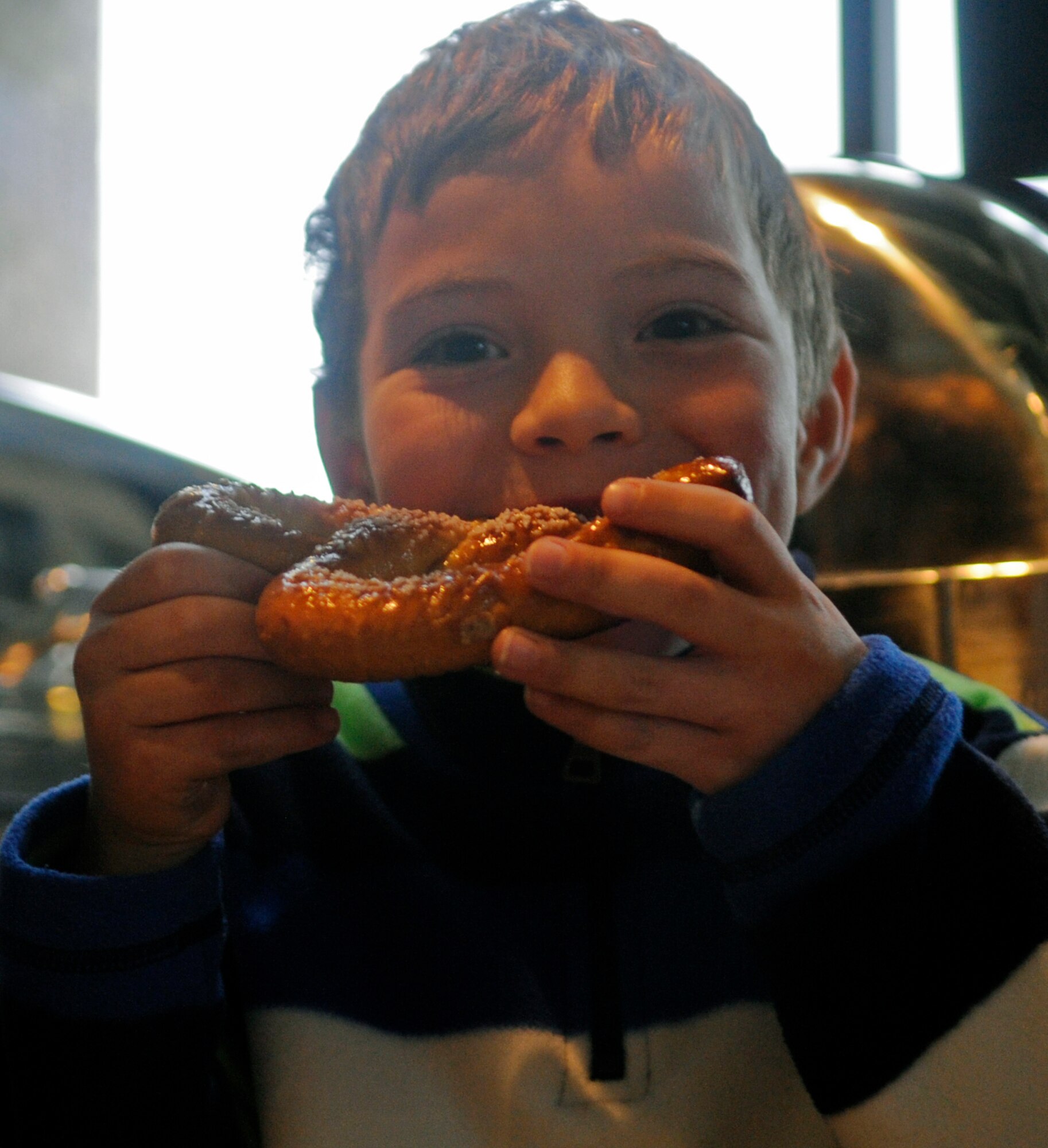 Devin White, son of U.S. Air Force Staff Sgt. Brian White, 495th Fighter Wing Detachment 303, races to finish his pretzel during an eating contest at the 2nd Annual Oktoberfest at Whiteman Air Force Base, Mo., Oct. 18, 2013. Oktoberfest included hay rides, costume contest and hammer schlagen game. (U.S. Air Force photo by Staff Sgt. Alexandra M. Boutte/Released)