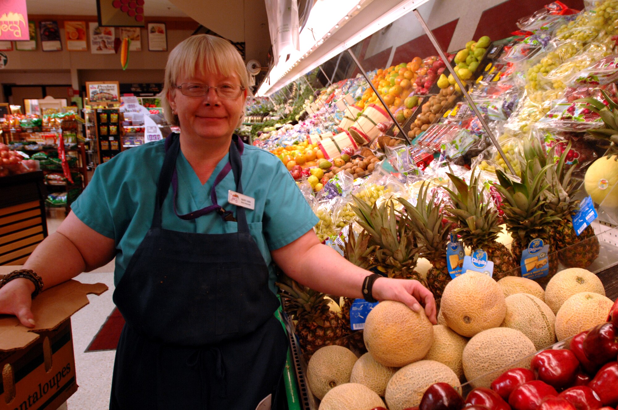 Mary Ann Smith, Grand Forks Air Force Base DeCA store associate, stocks fresh fruit in the produce section of the commissary on Grand Forks Air Force Base, N.D., Oct. 30, 2013. Smith was chosen as the Warrior of the Week for the fifth week of October 2013. (U.S. Air Force photo/Staff Sgt. Susan L. Davis)