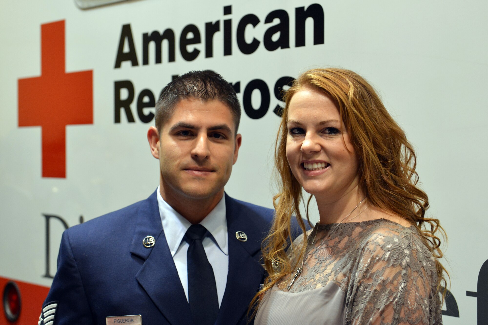 Staff Sgt. Angelo Figueroa, 10th Airlift Squadron loadmaster and his wife Kristine stop for a photo in front of the American Red Cross vehicle at the Mount Rainier Chapter Red Cross Heroes Breakfast, Oct. 23, 2013 in Tacoma, Wash. The Figueroa's were presented with the Good Samartian Award during this annual event. (U.S. Air Force photo/Staff Sgt. Jason Truskowski)