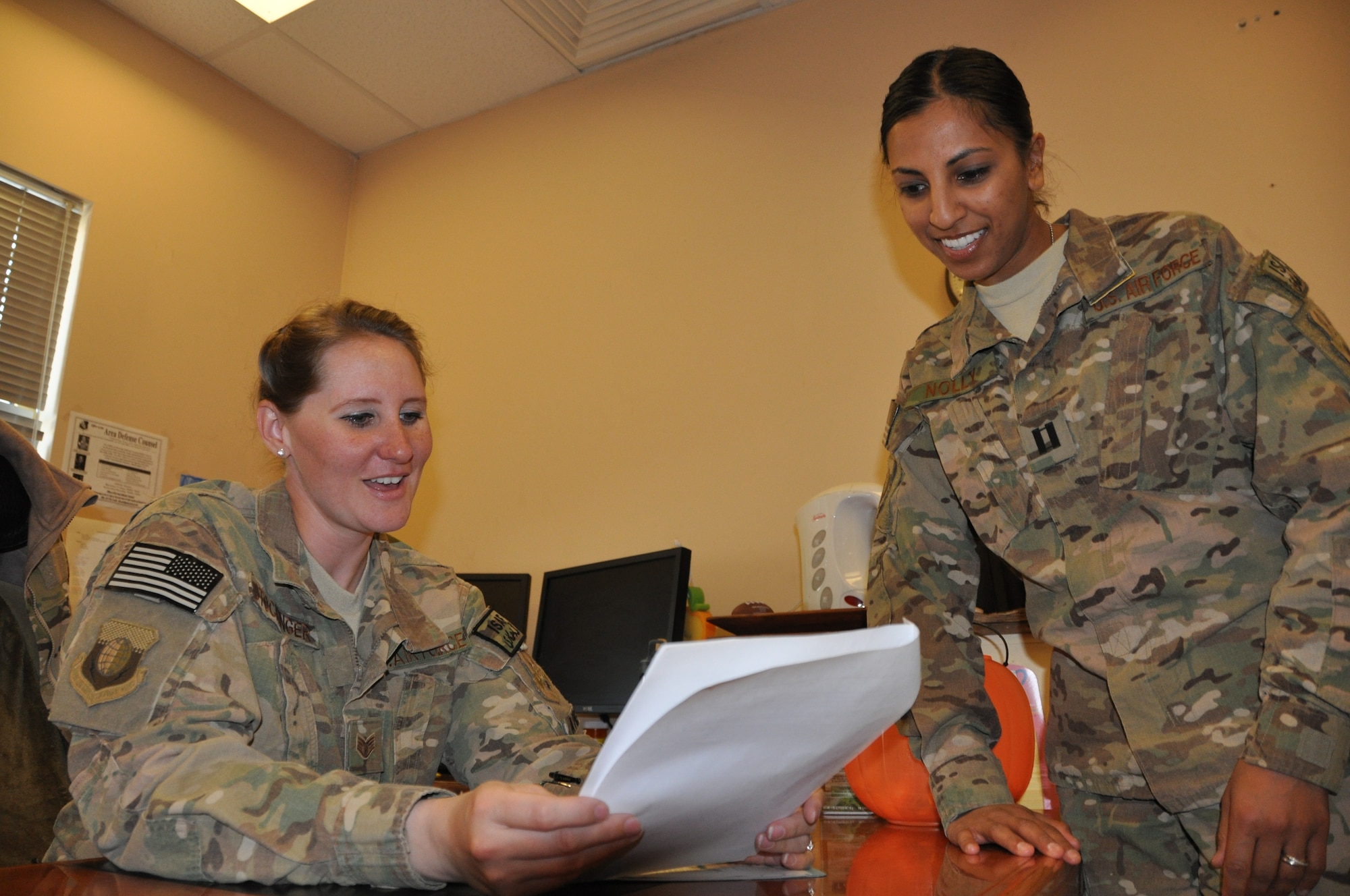 Capt. Dimple Nolly, 455th Air Expeditionary Wing deputy staff judge advocate, deployed from Spangdahlem Air Base, Germany, and a Houston native, talks with Staff Sgt. Megan Stockinger, 455 AEW NCO in charge of military justice, deployed from Little Rock Air Force Base, Ark., and a native of Geneva, Ala., on Bagram Airfield, Afghanistan, Oct. 29, 2013. (U.S. Air Force photo/Tech. Sgt. Rob Hazelett)