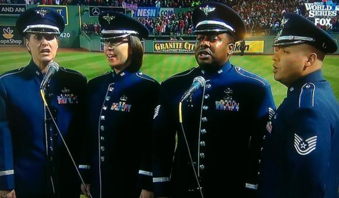 Master Sergeant Jennifer Dashnaw, Technical Sergeant Niko Ellison, Technical Sergeant Quez Basquez, and Staff Sergeant Rachel Webber of the Air Force Heritage of America Band sing "God Bless America" during the seventh-inning stretch of Game 6 of the World Series. (Daily Press / October 30, 2013)