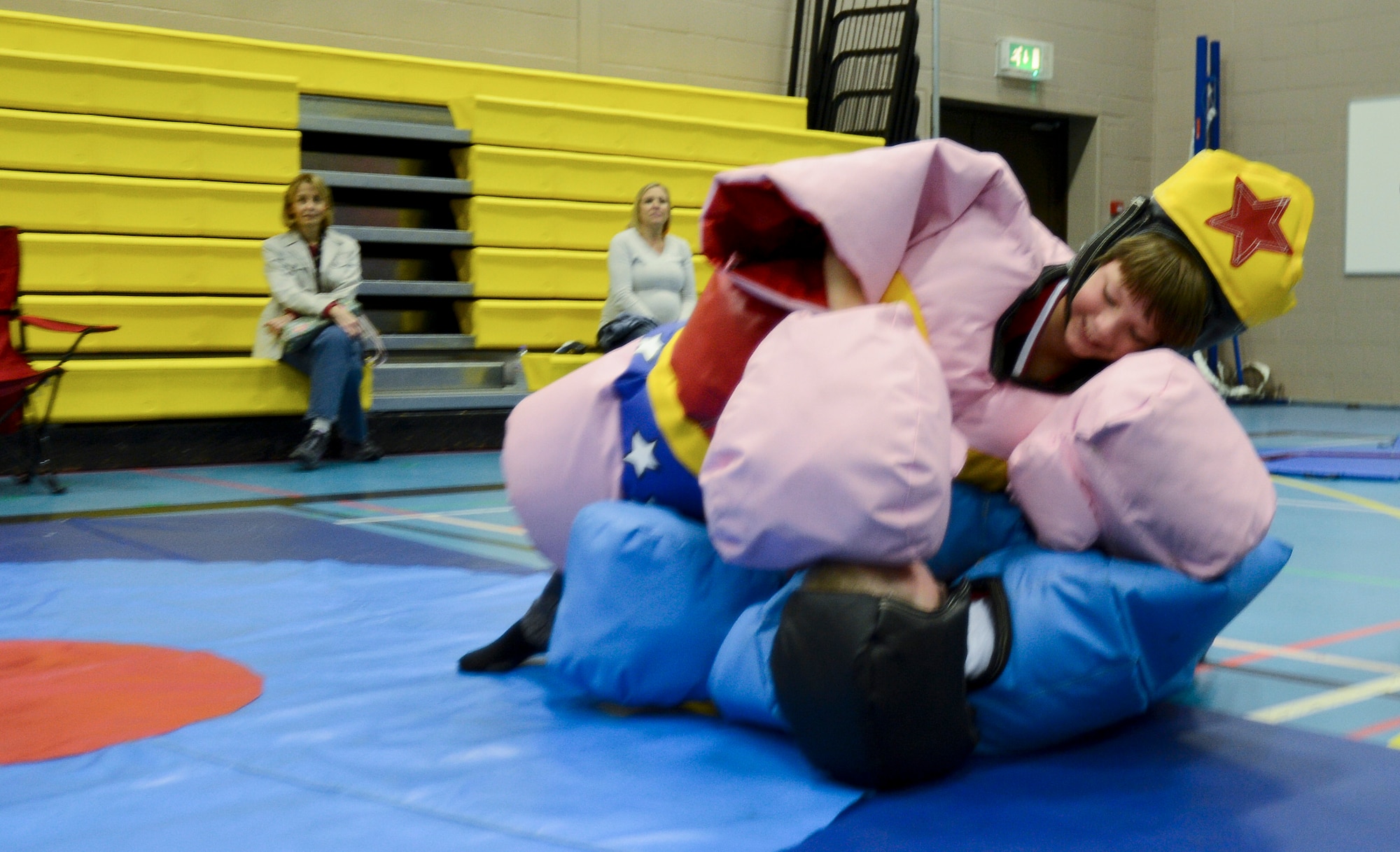 Isaac Rivard, 9-year-old son of Lt. Col. Joel Rivard, 351st Air Refueling Squadron director of operations, pins his opponent John McGuire, 8-year-old son of Master Sgt. John McGuire, 352nd Special Operations Group, at Royal Air Force Feltwell, England, during the Haunted Harley Spooktacular at the middle school Oct. 26, 2013. The local Harley Owners Group sponsored the event to promote a drug-free life and raise donations for the Combined Federal Campaign charity drive. (U.S. Air Force photo by Staff Sgt. Thomas Trower/Released)