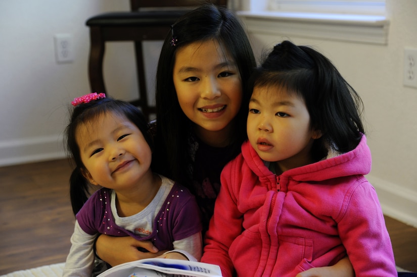 From left, Mary, Grace and Sophia Hong, daughters of U.S. Army Sgt. David Hong, Fort Eustis chaplain assistant, pose in their home at Fort Eustis, Va., Oct. 21, 2013. Sophia has Dravet syndrome, a rare form of intractable epilepsy that begins in infancy, and due to her condition, Grace and Mary always keep a close eye on their sister. (U.S. Air Force photo by Airman 1st Class Austin Harvill/Released)