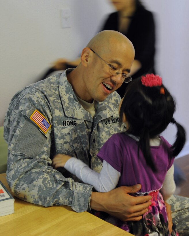 U.S. Army Sgt. David Hong, Fort Eustis chaplain assistant, talks with his daughter, Mary, after work at Fort Eustis, Va., Oct. 21, 2013. Mary's sister, Sophia, has Dravet syndrome, a rare form of intractable epilepsy that begins in infancy and causes severe seizures and delayed development. (U.S. Air Force photo by Airman 1st Class Austin Harvill/Released)