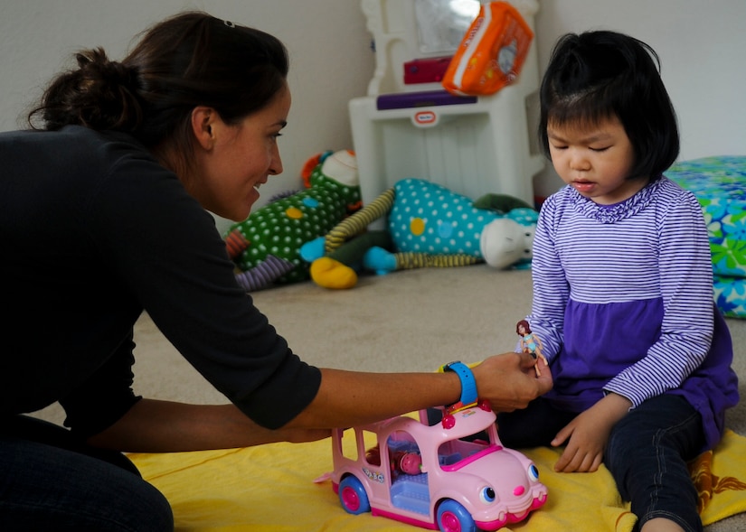 Alona Luckey, an Applied Behavioral Analysis tutor, plays with Sophia, 5-year-old daughter of U.S. Army Sgt. David Hong, Fort Eustis chaplain assistant, at Fort Eustis, Va., Oct. 7, 2013. Sophia has Dravet syndrome, a rare form of intractable epilepsy that begins during infancy, and has to sleep in a room full of mattresses as most of her seizures happen at night. (U.S. Air Force photo by Airman 1st Class Austin Harvill/Released)
