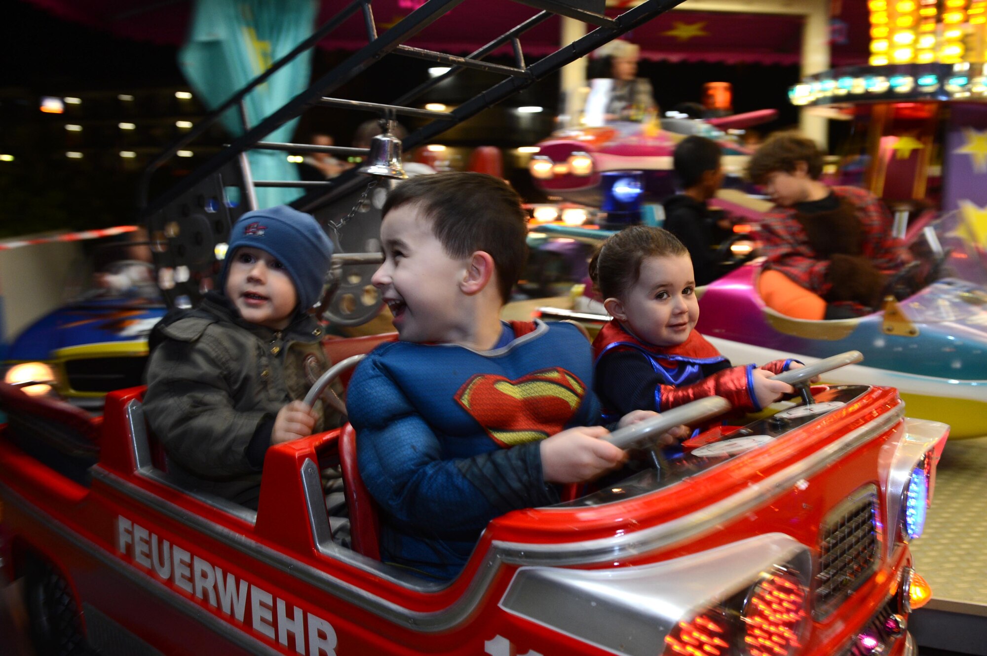 SPANGDAHLEM AIR BASE, Germany – Laszlo and Elena Porter, children of Staff Sgt. Jonathan Porter, American Forces Network-Spangdahlem broadcaster, ride on a children’s carousal at the Halloween block party at Club Eifel Oct. 30, 2013. The 52nd Force Support Squadron hosts a Halloween block party for the community at no cost. (U.S. Air Force photo by Airman 1st Class Kyle Gese/Released)