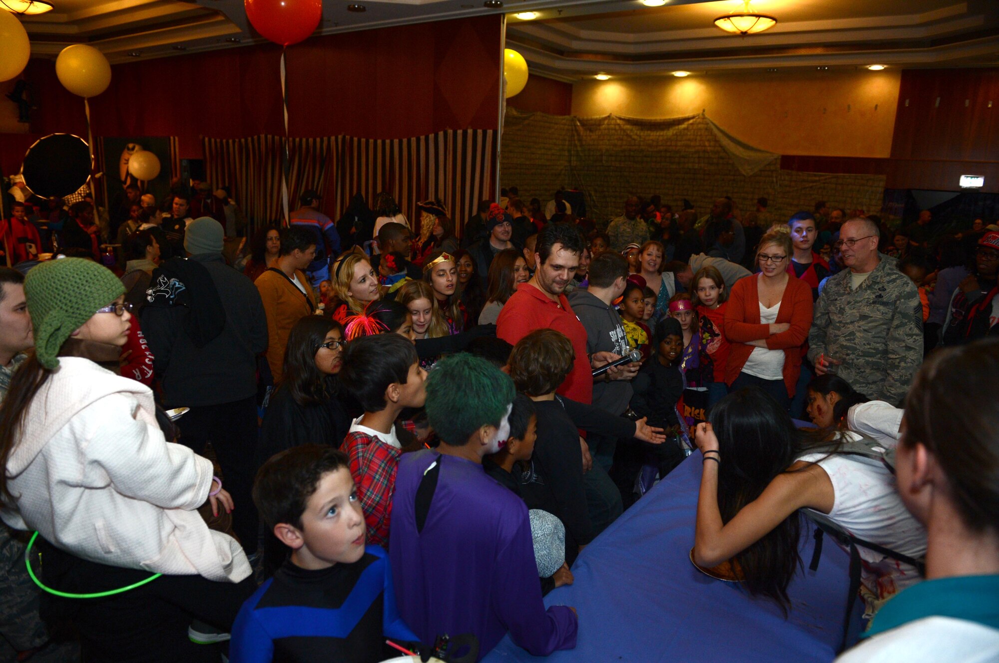 SPANGDAHLEM AIR BASE, Germany – Halloween block party participants gather to watch a pie eating contest at the Club Eifel Oct. 30, 2013. There were several games for children to participate in such as hay rides, pie eating contests, paintball games, rides, and trunk or treating. (U.S. Air Force photo by Airman 1st Class Kyle Gese/Released)