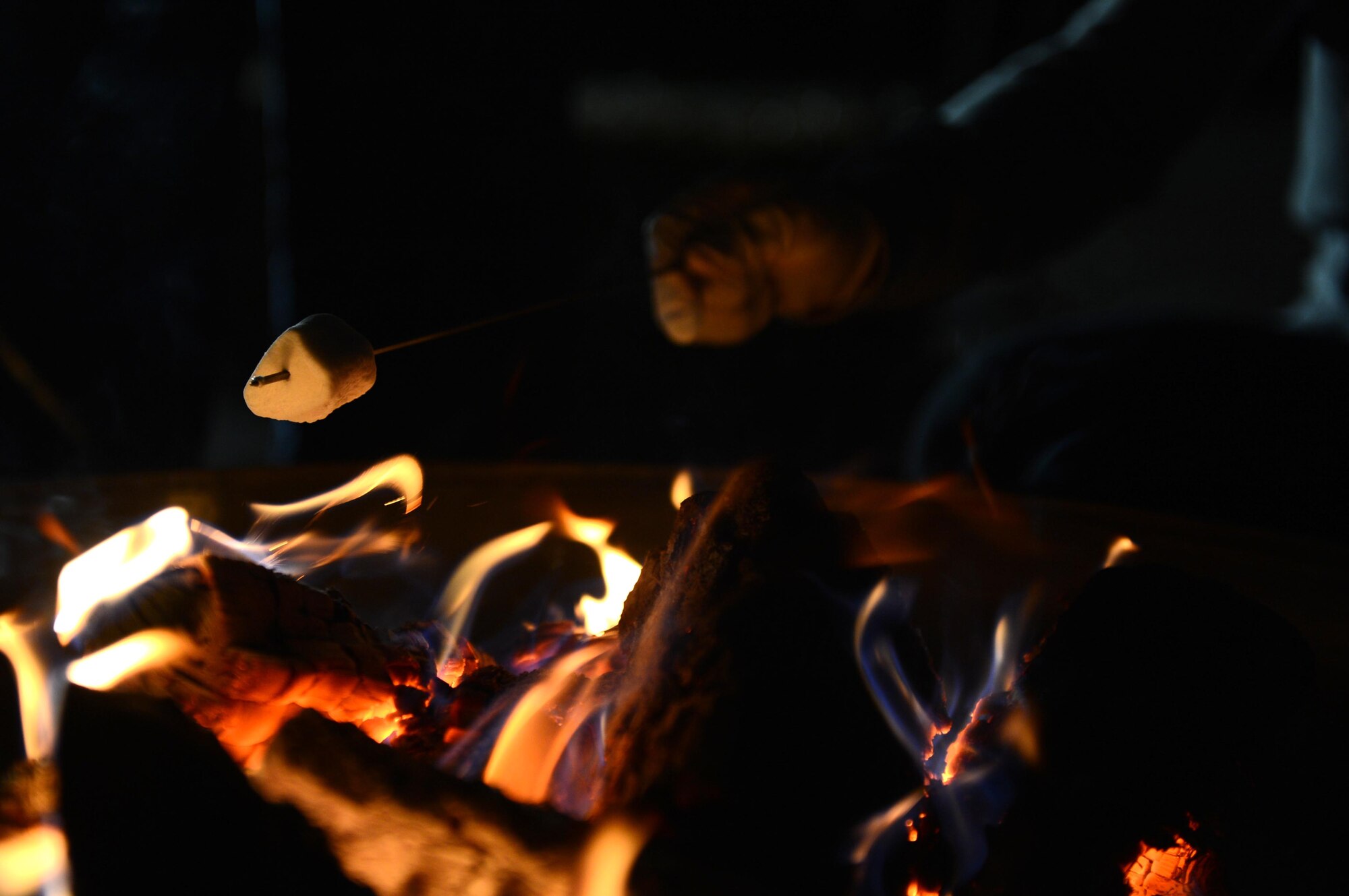 SPANGDAHLEM AIR BASE, Germany – An attendee of the Halloween block party roasts a marshmallow over a fire at Club Eifel Oct. 30, 2013. Volunteers handed S’mores out to children at the block party as part of the Halloween fun. (U.S. Air Force photo by Airman 1st Class Kyle Gese/Released)