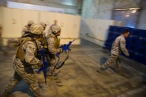 Airmen participating in the 91st Security Support Squadron tactical response force tryouts follow Master Sgt. Joseph Anderson, 91st SSPTS TRF superintendent to the shoot-house for the next portion of the tryouts.  The 91st SSPTS TRF tryouts are structured to test Airmen physical and mental ability during high pressure situations.  (U.S. Air Force photo/Senior Airman Brittany Y. Auld)