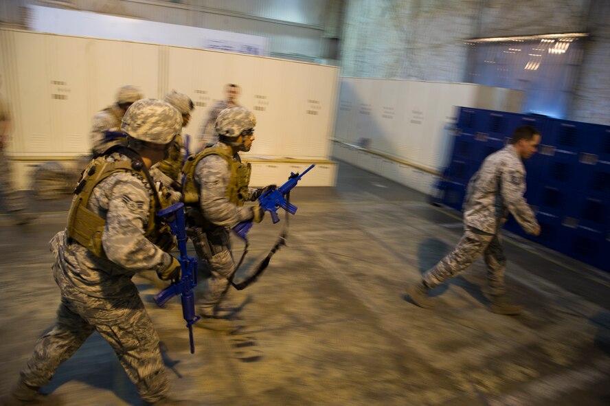 Airmen participating in the 91st Security Support Squadron tactical response force tryouts follow Master Sgt. Joseph Anderson, 91st SSPTS TRF superintendent to the shoot-house for the next portion of the tryouts.  The 91st SSPTS TRF tryouts are structured to test Airmen physical and mental ability during high pressure situations.  (U.S. Air Force photo/Senior Airman Brittany Y. Auld)