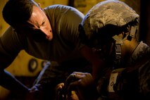 Staff Sgt. William Mack, 91st Security Support Squadron tactical response force member tries to distract Senior Airman Arthur Moody, 91st Missile Security Forces member while he puts together a M-4 rifle at Minot Air Force Base, N.D., Oct. 29. TRF tryout process can last anywhere from six to eight hours. (U.S. Air Force photo/Senior Airman Brittany Y. Auld)