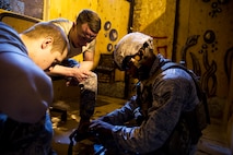 Staff Sgt. William Mack and Senior Airman Matthew LoMonaco, 91st Security Support Squadron tactical response force members watch as Senior Airman Arthur Moody, 91st Missile Security Forces member assemble a M-4 rifle at Minot Air Force Base, N.D., Oct. 29. Tryouts are expected to implement the knowledge Airmen are taught from the glass house drills into the shoot house iterations. The training tempo and stress are kept at a high throughout the process. (U.S. Air Force photo/Senior Airman Brittany Y. Auld)