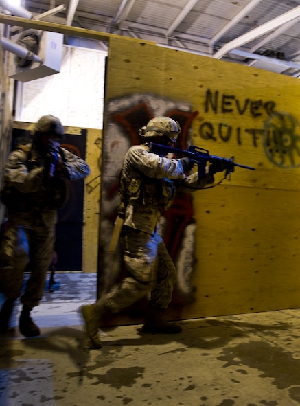 Senior Airman Arthur Moody, 91st Missile Security Forces member and Senior Airman Derrick Besser, 791st Missile Security Forces member tactically move through a shoot house during the 91st Security Support Squadron tactical response force tryouts at Minot Air Force Base, N.D., Oct. 29. The mission of the 91st SSPTS TRF is to respond to hostile attacks anywhere they occur within the 91st Missile Wing Intercontinental Ballistic Missile complex and to use all means necessary to defeat the adversary.  (U.S. Air Force photo/Senior Airman Brittany Y. Auld)
