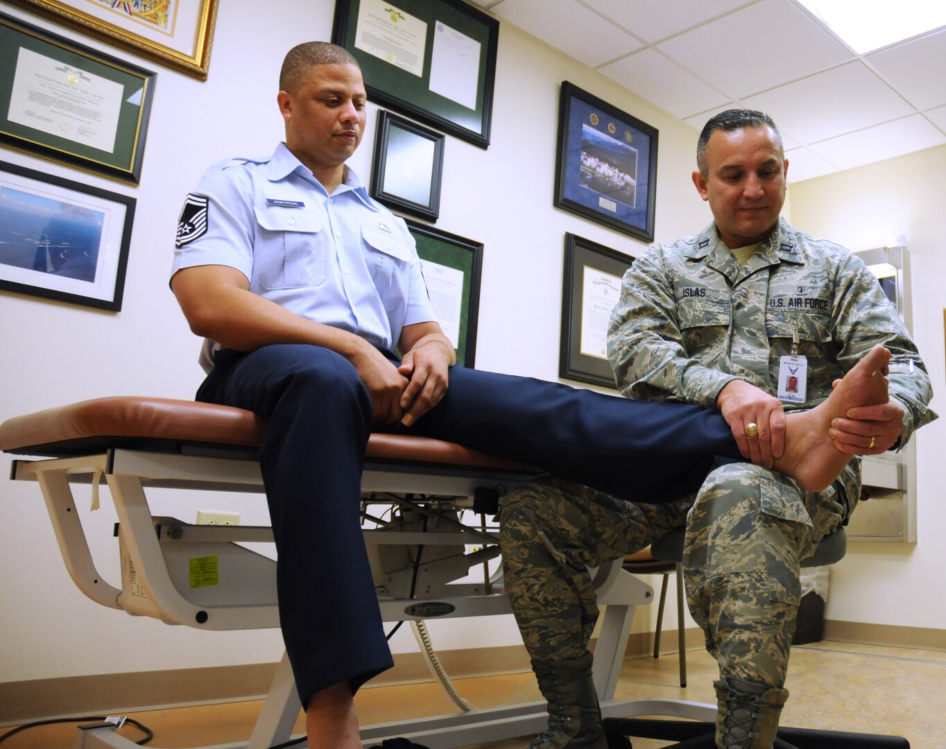 Senior Master Sgt. Travis Armstrong (left), Air Force Personnel Center, receives treatment from Capt. Felix Islas, 359th Medical Group Physical Therapy Flight commander, July 15 at the Joint Base San Antonio-Randolph medical clinic. The purpose of physical therapy is to rehabilitate a patient’s body to full functioning capacity. (U.S. Air Force photo by Airman 1st Class Alexandria Slade)