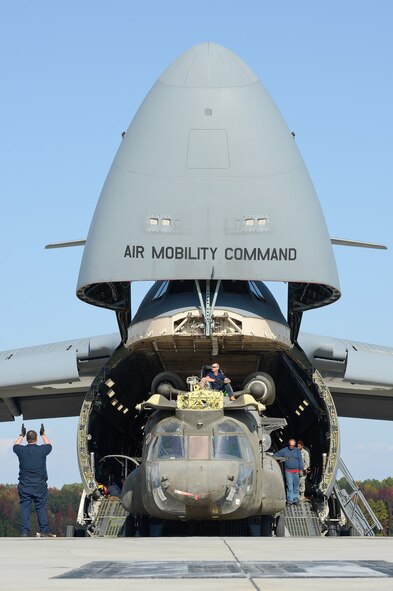 United States Army CH-47D Chinook helicopters and their components are unloaded from a C-5M Super Galaxy of the 436th Airlift Wing, Oct. 29, 2013, Dover Air Force Base, Del. The helicopters were used in Afghanistan and are being returned to the United States as military forces are withdrawn from the country. (U.S. Air Force photo/Greg L. Davis)