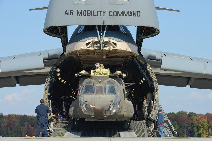 United States Army CH-47D Chinook helicopters and their components are unloaded from a C-5M Super Galaxy of the 436th Airlift Wing, Oct. 29, 2013, Dover Air Force Base, Del. The helicopters were used in Afghanistan and are being returned to the United States as military forces are withdrawn from the country. (U.S. Air Force photo/Greg L. Davis)