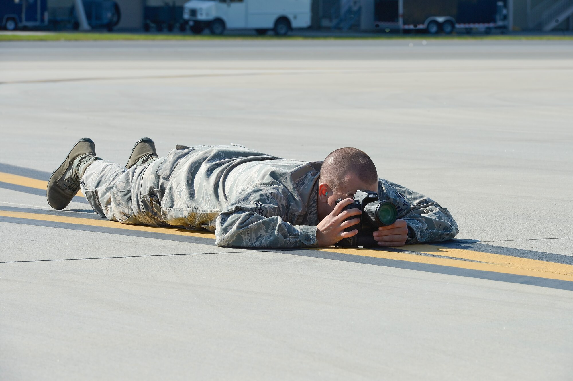 Airman 1st Class William Johnson, 436th Airlift Wing Public Affairs photographer, documents the unloading of two United States Army CH-47D Chinook helicopters from a C-5M Super Galaxy of the 436th Airlift Wing on Oct. 29, 2013, Dover Air Force Base, Del. (U.S. Air Force photo/Greg L. Davis)       