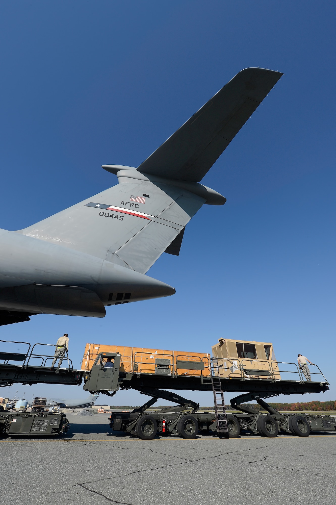 Cargo is unloaded from a C-5B Galaxy of the 433th Airlift Wing, Air Force Reserve Command, at Dover Air Force Base, Del. on Oct. 29, 2013. The large transport aircraft is based at Joint Base San Antonio/Lackland, Texas and is returning equipment to the United States as military forces are withdrawn from Afghanistan. (U.S. Air Force photo/Greg L. Davis)
