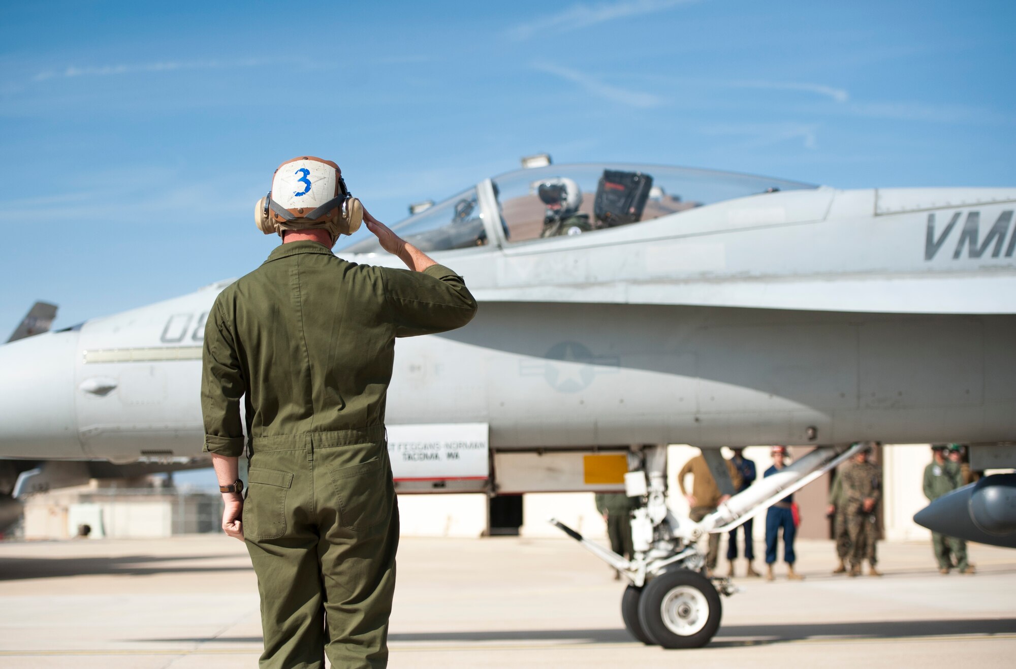 A U.S. Marine corps crew chief gives a salute as an F-18 Hornet taxis for a Max Thunder sortie at Kunsan Air Base, Republic of Korea, Oct. 30, 2013. Maintainers from the Max Thunder team worked day and night in order to maintain the schedule. This is the 11th Max Thunder exercise, which fosters bilateral aerial training between the Korea Air Power Team to include the U.S. Air Force, Marine Corps and the Republic of Korea air force. (U.S. Air Force photo by Senior Airman Armando A. Schwier-Morales)