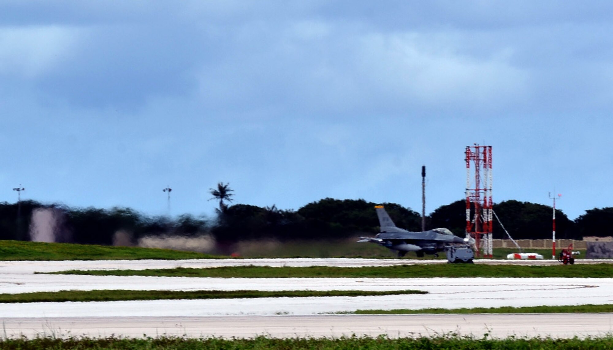 A 14th Fighter Squadron F-16 Fighting Falcon pilot from Misawa Air Base, Japan, begins takeoff as a part of a training mission on Andersen Air Force Base, Guam, Oct. 29, 2013. Andersen has operated as a host base for the Aviation Training Relocation program since 2011, when it was selected by a joint Japan-U.S. committee due to the limited flying regulations and close proximity to local populations in Japan.(U.S. Air Force photo by Airman 1st Class Mariah Haddenham/Released)