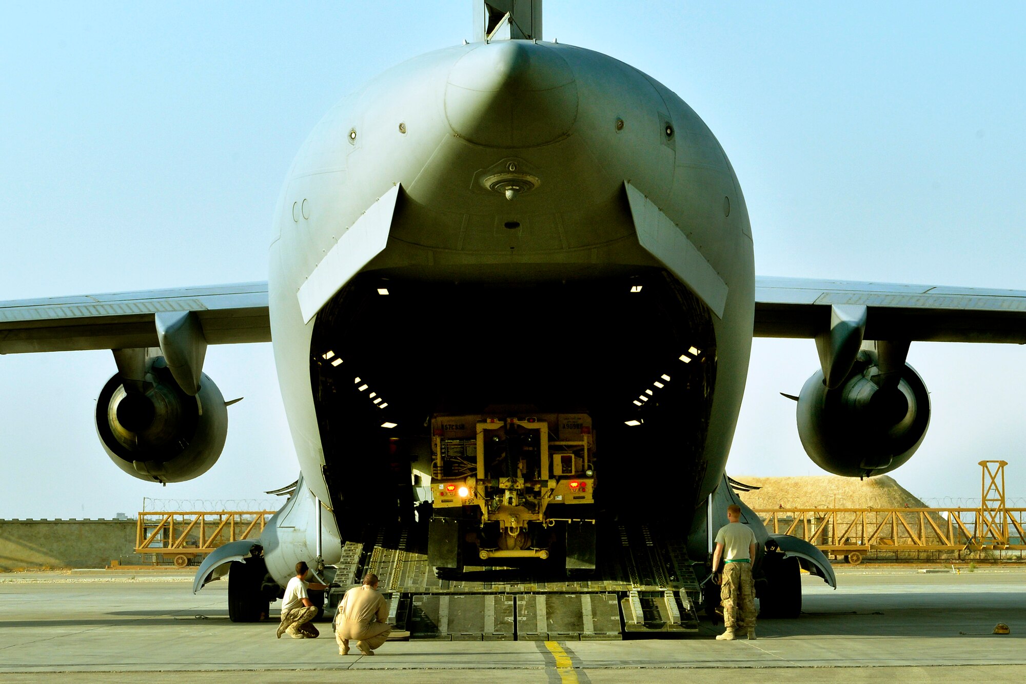 Airmen assigned to the 455th Aerial Port Squadron offload a wrecker vehicle on Forward Operating Base Mazar-E-Sharif, Afghanistan. The C-17 is deployed from Dover Air Force Base, De. (U.S. Air Force photo/Staff Sgt. Stephenie Wade)