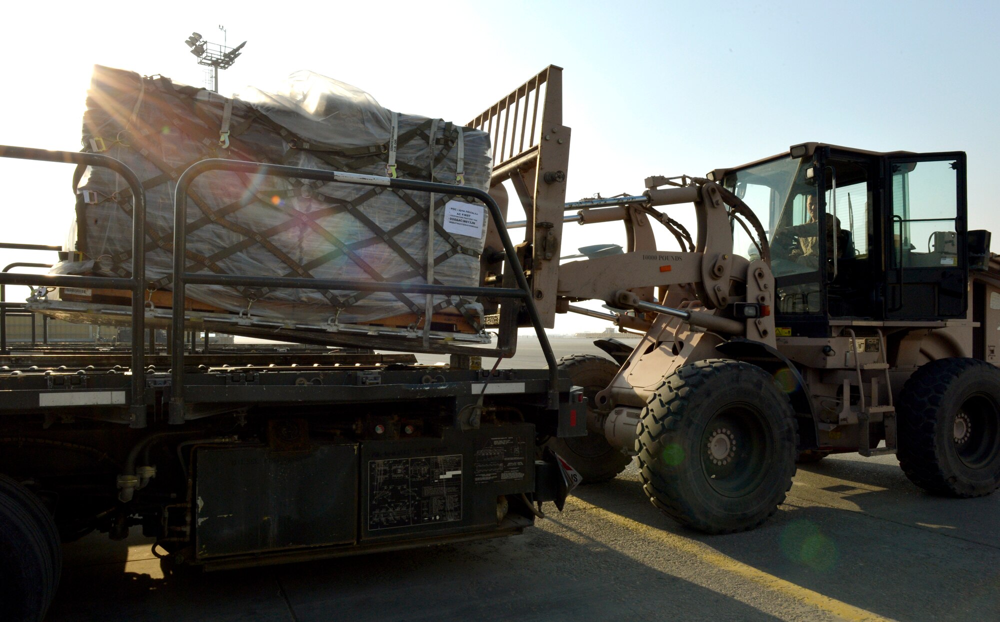 Senior Airman James Harrison, a 455th aerial port journeyman uses a forklift to offload cargo from a K-loader after it was removed from an aircraft on Forward Operating Base Mazar-E-Sharif, Afghanistan. Harrison is a native of and deployed from on his first deployment from Charleston, S.C.  (U.S. Air Force photo/Staff Sgt. Stephenie Wade)