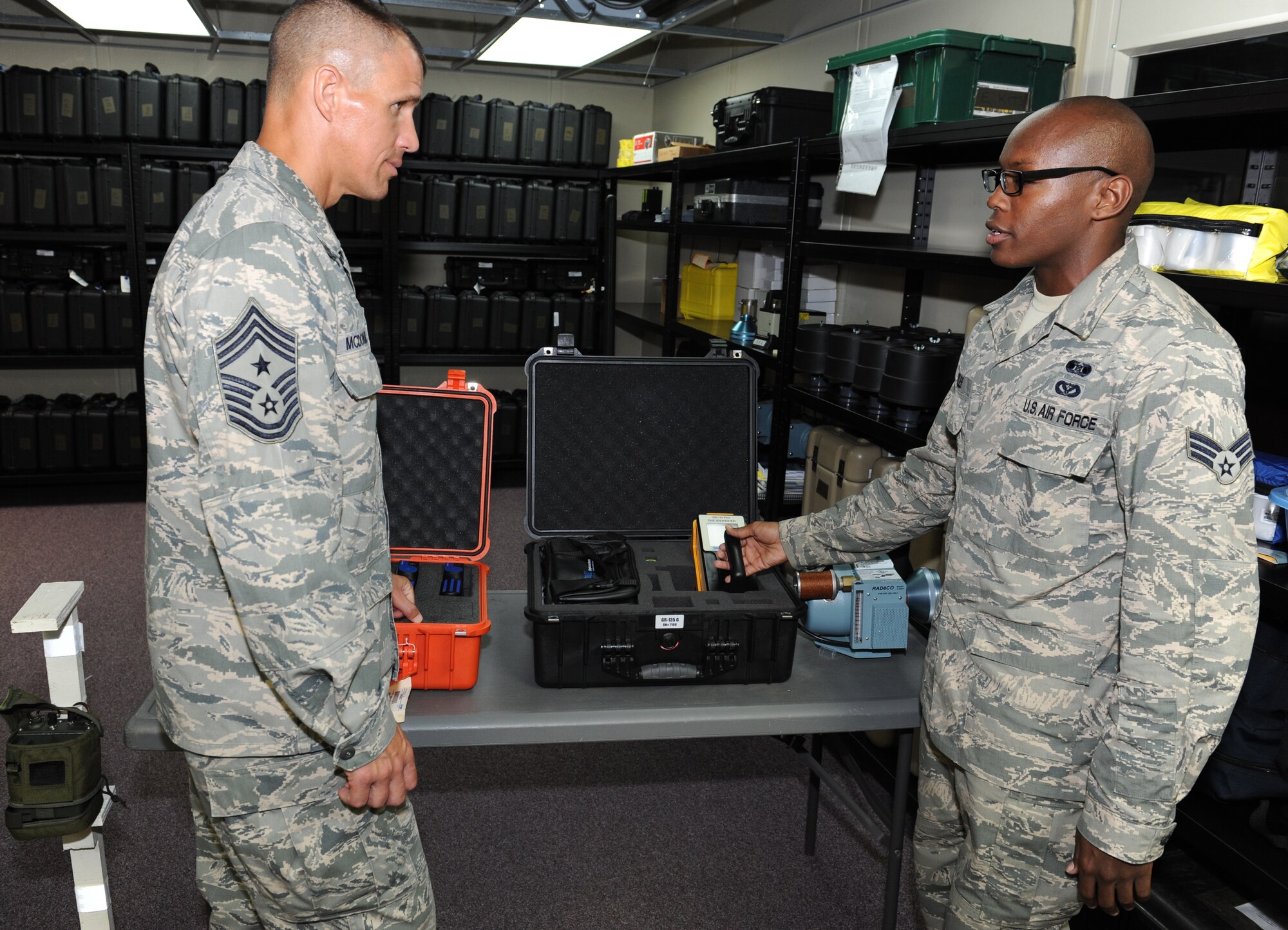 U.S. Air Force Senior Airman Matthew Bryles, 18th Civil Engineer Squadron emergency management journeymen, briefs Chief Master Sgt. Steve McDonald, Pacific Air Forces command chief, about the GR-135 on Kadena Air Base, Japan, Oct. 29, 2013. The GR-135 tests the radiation levels in the area and identifies the exact isotope when responding to all hazardous incidents.  (U.S. Air Force photo by Airman 1st Class Keith James)
