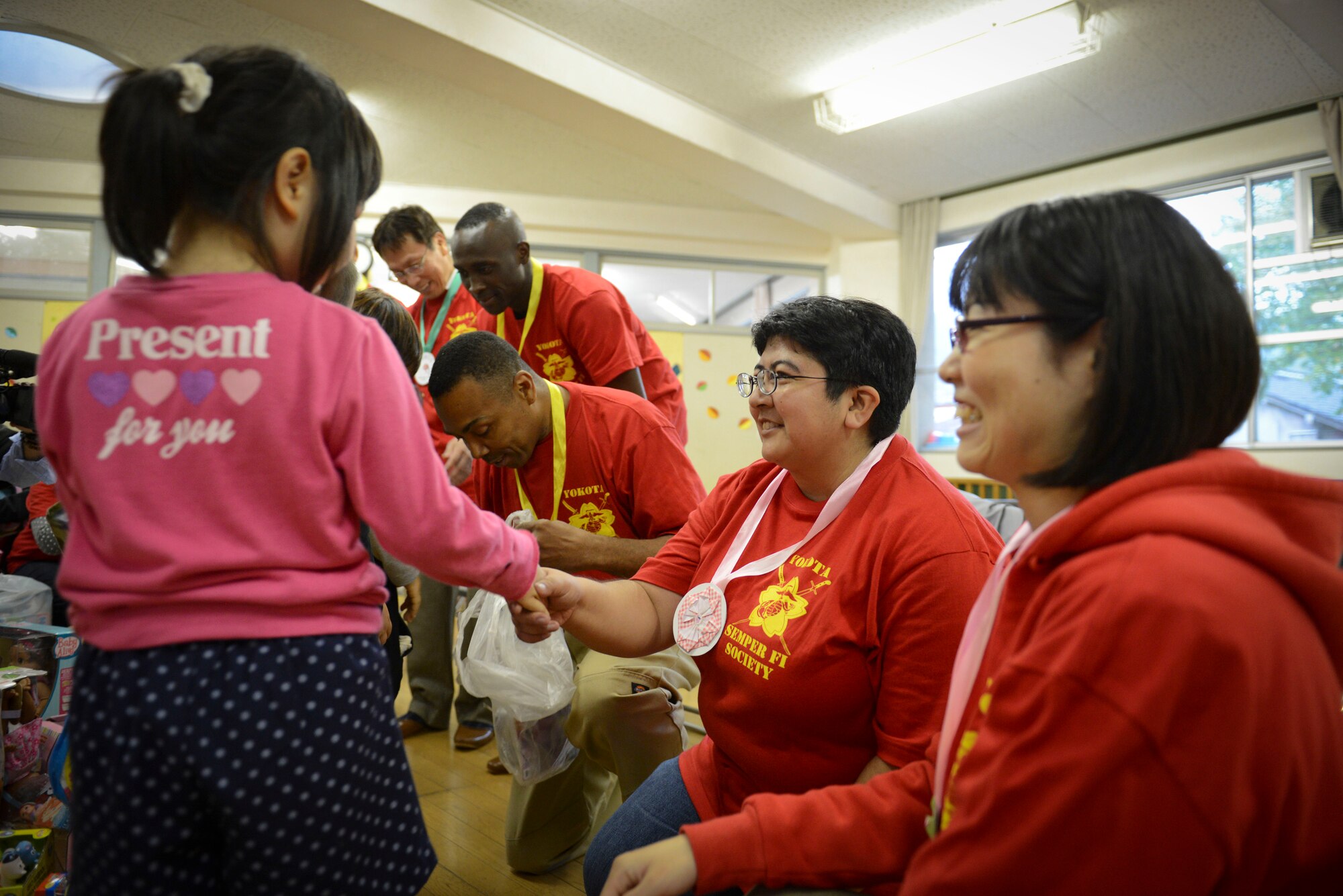 A girl from the Kaminakajima preschool shakes Anastasia Moreno's hand, coordinator of the toy drop and vice president of the Semper Fi Society, in Kamaishi-shi, Japan, Oct. 25, 2013.  200 toys were delivered this year to children in Kamaishi. (U.S. Air Force photo by Airman 1st Class Meagan Schutter/Released)