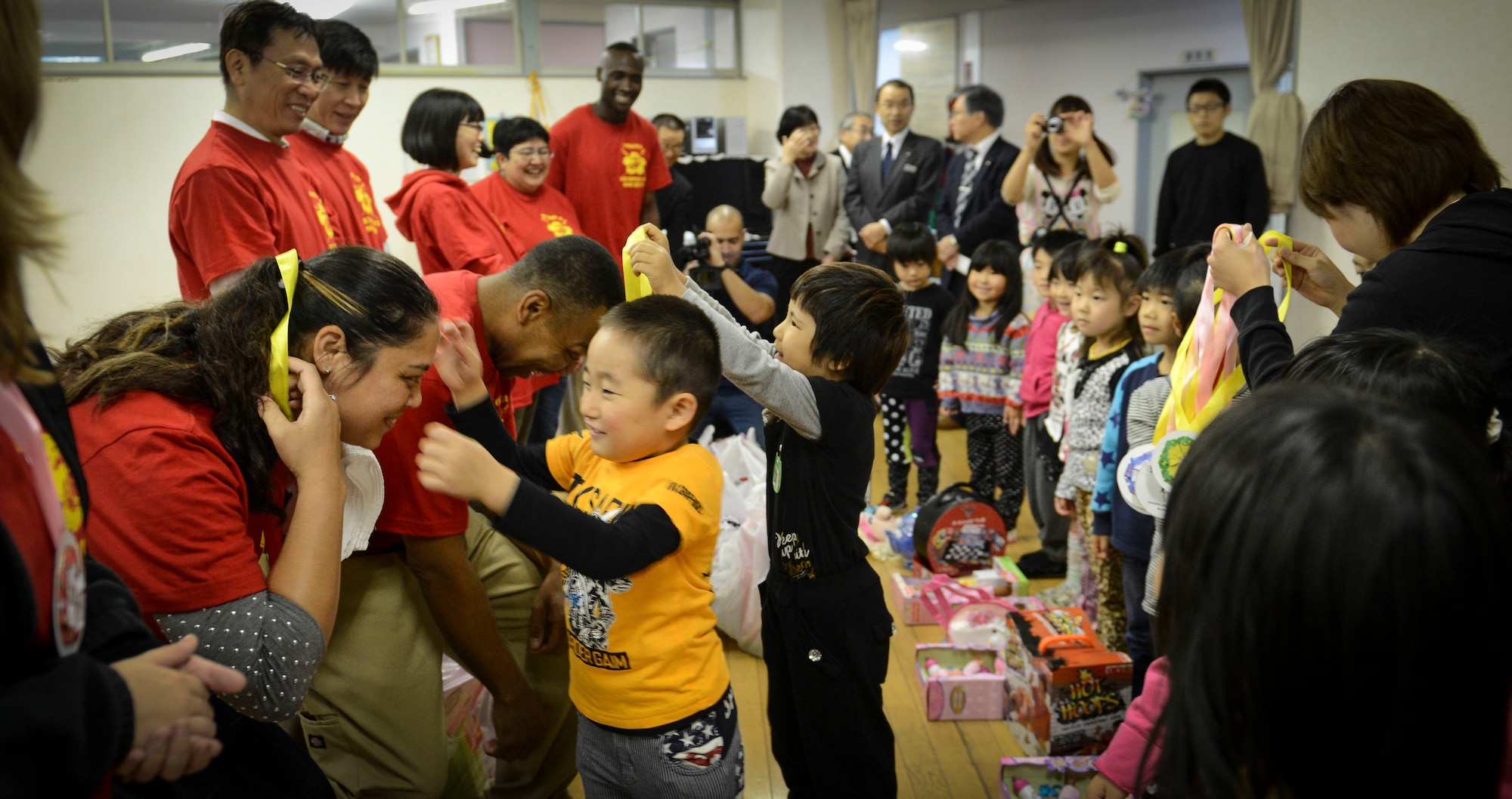 Members of the Semper Fi Society receive a gift from the children at Kaminakajima preschool in Kamaishi-shi, Japan, Oct. 25, 2013 as thanks for their donations.  200 toys were delivered this year to children in Kamaishi. (U.S. Air Force photo by Airman 1st Class Meagan Schutter/Released)