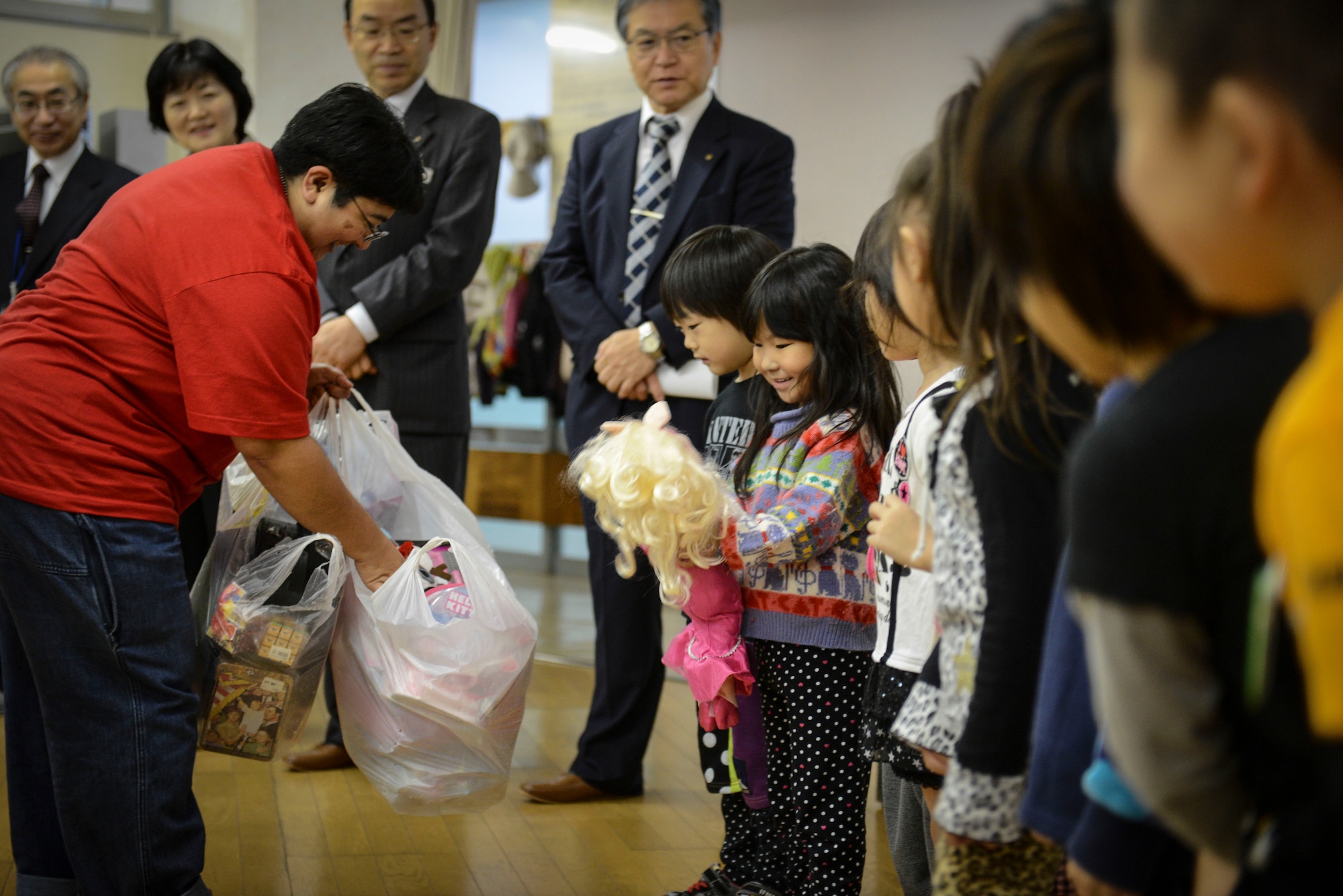 A girl smiles after receiving a gift from Anastasia Moreno, vice president of the Semper Fi Society, at Kaminakajima preschool in Kamaishi-shi, Japan, Oct. 25, 2013.  The society hopes to be able to gather 300-400 toys to distribute to more cities in the Tohoku Region in the future. (U.S. Air Force photo by Airman 1st Class Meagan Schutter/Released)