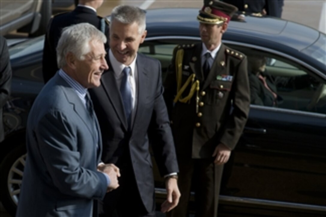 Secretary of Defense Chuck Hagel, left, greets Latvian Minister of Defense Artis Pabriks upon his arrival at the Pentagon in Arlington, Va., on Oct. 28, 2013.  Hagel and Pabriks will meet to discuss national and regional security items of interest to both nations.  