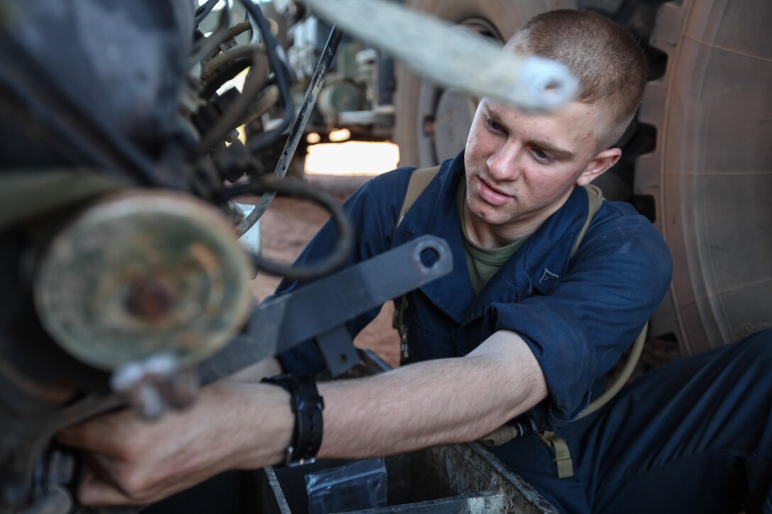 Lance Cpl. Chase J. Dusenbury, an 18-year-old motor transportation mechanic for Combat Logistics Battalion 31, 31st Marine Expeditionary Unit, and a native of Lexington, S.C., removes attachments from the engine of a High Mobility, Multi-Purpose Wheeled Vehicle here, Sept. 1. The Marines of CLB-31’s maintenance section are working long days and late nights to keep pace with the required maintenance that comes with supporting the battalion-sized element currently executing Exercise Koolendong 13. Koolendong is a week-long, live-fire exercise that demonstrates the operational reach of the 31st MEU. Also participating in the exercise is the Marine Rotational Force – Darwin and soldiers of the 5th Royal Australian Regiment. The 31st MEU brings what it needs to sustain itself to accomplish the mission or to pave the way for follow-on forces. The 31st MEU is the Marine Corps' force in readiness for the Asia-Pacific region and the only continuously forward-deployed MEU. 