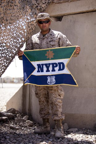Sgt. Jonathan Vasquez, a New York City police officer and Marine with Combat Logistics Regiment 2, Regional Command (Southwest), currently serving in Helmand province, Afghanistan, poses for a photo after sending a video message to show his support for the city and people of New York Aug. 20, 2013. Many of the Marines serving with CLR-2 are reservists from 6th Communications Battalion, a Marine Corps Reserves unit based out of Brooklyn. They recently deployed in support of Operation Enduring Freedom in July.