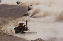 Clouds of dust fill the air as a convoy of vehicles with Combat Logistics Regiment 2, Regional Command (Southwest), conducts a logistics patrol Aug. 22, 2013, in Helmand province, Afghanistan. More than 30 vehicles took part in the convoy, which provided simultaneous support to Forward Operating Bases Shir Ghazi and Shukvani.