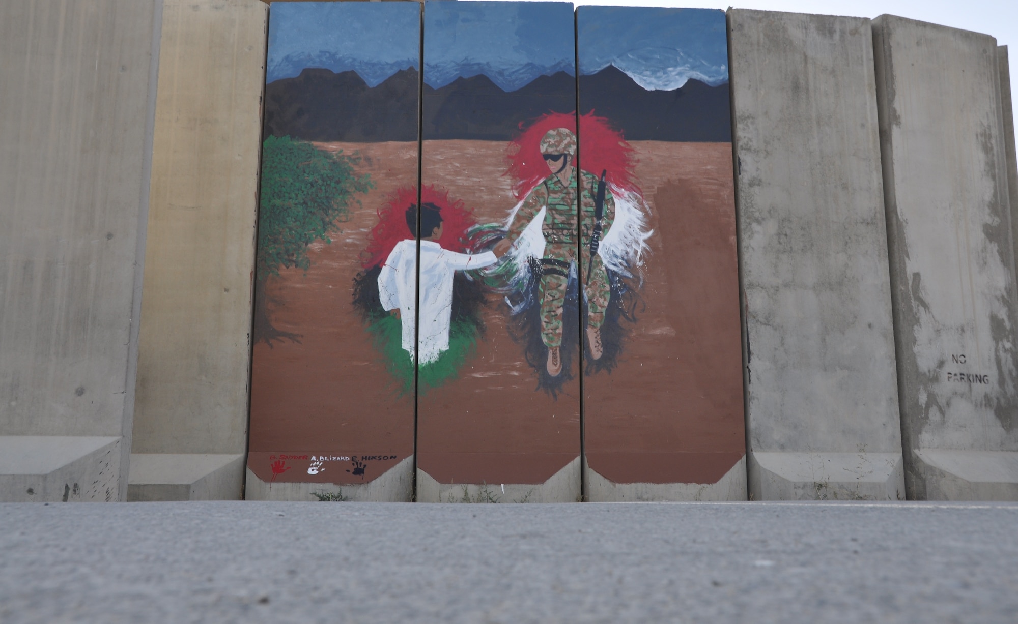 Three Airmen painted their interpretation of unity, respect, trust, strength and the will to protect on a wall leaving a visual legacy for those who follow in their footsteps Aug. 30, 2013, at Camp Cunningham. (U.S. Air Force photo/Tech. Sgt. Rob Hazelett)