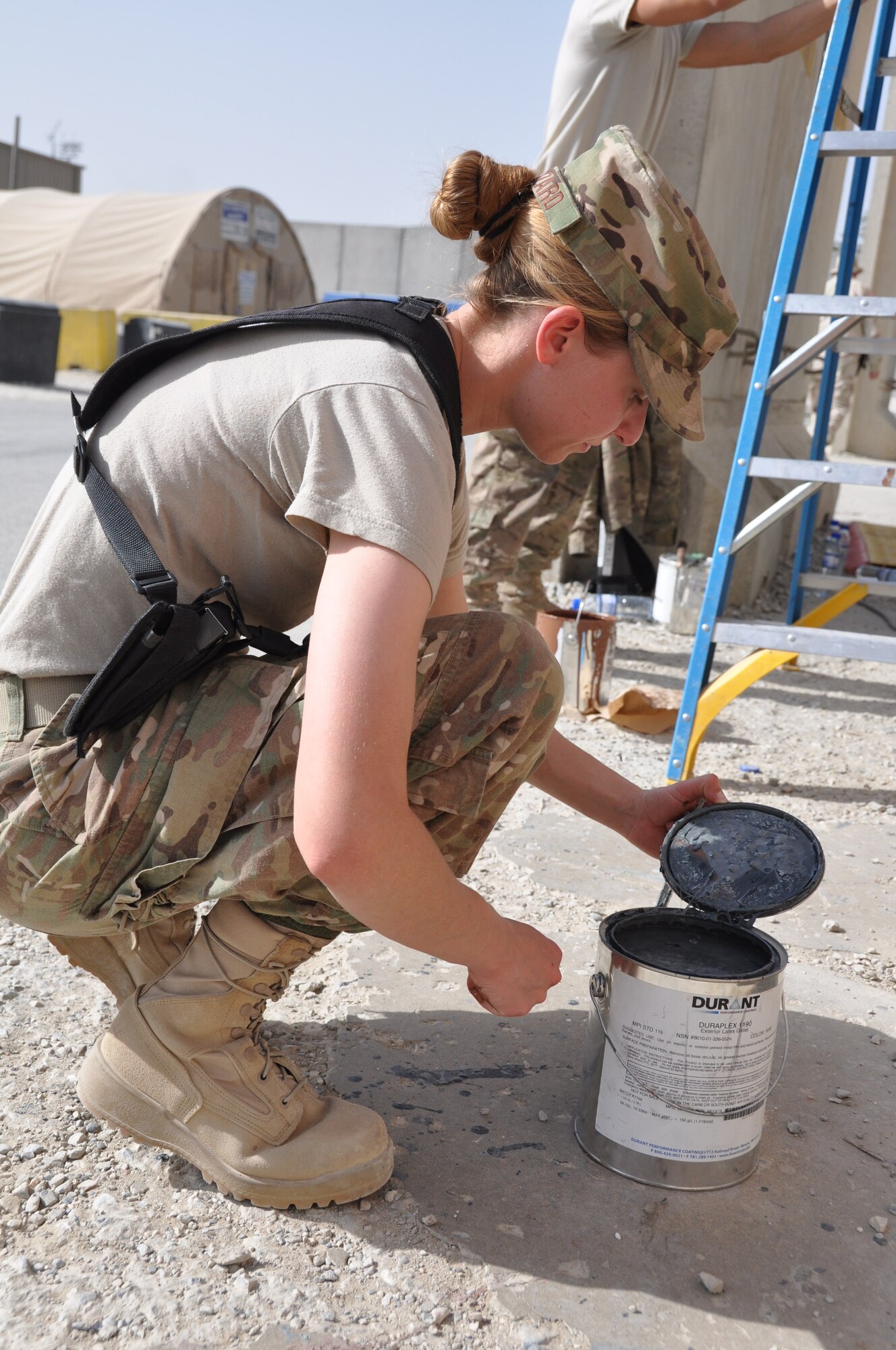 Senior Airman Alyona Blizard, 455th Expeditionary Communications Squadron communications focal point technician, paints a mural depicting the bonds, unity, respect, trust, strength and the will to protect on the walls on Bagram Airfield, Afghanistan, Aug. 30, 2013. Blizard is deployed from Joint Base Langley-Eustis AFB, Va. She is a three-year Air Force veteran who hails from Beckley, W.Va. (U.S. Air Force photo/Tech. Sgt. Rob Hazelett)	