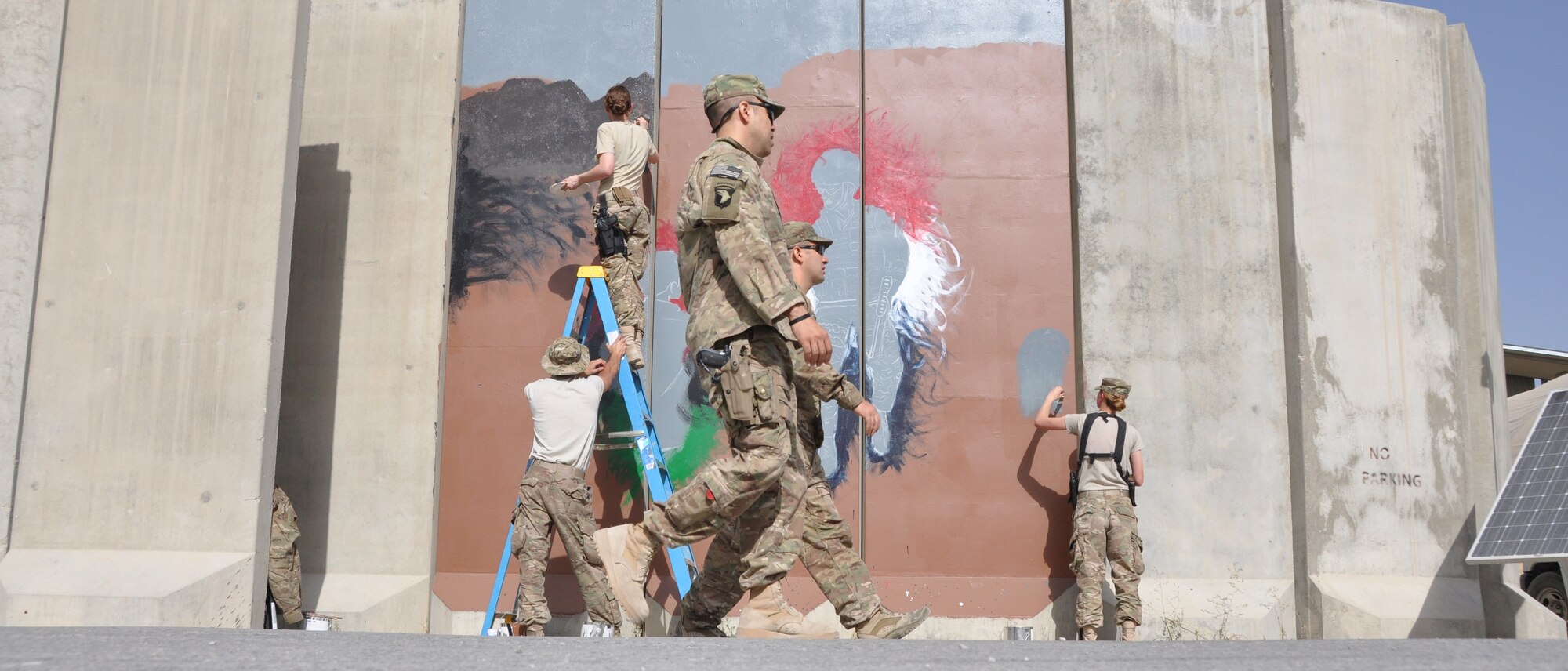 Three Airmen painted their interpretation of unity, respect, trust, strength and the will to protect on a wall leaving a visual legacy for those who follow in their footsteps to see here on Camp Cunningham Aug. 30, 2013. (U.S. Air Force photo/Tech. Sgt. Rob Hazelett)	